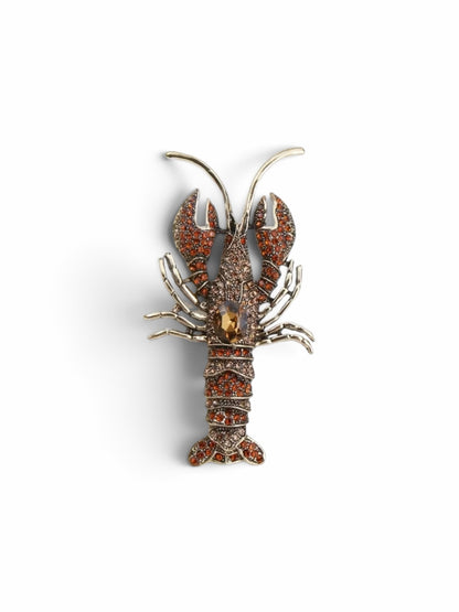 Luna Cotton amber crystal lobster lapel pin brooch with a central faceted stone and intricate metalwork detail.