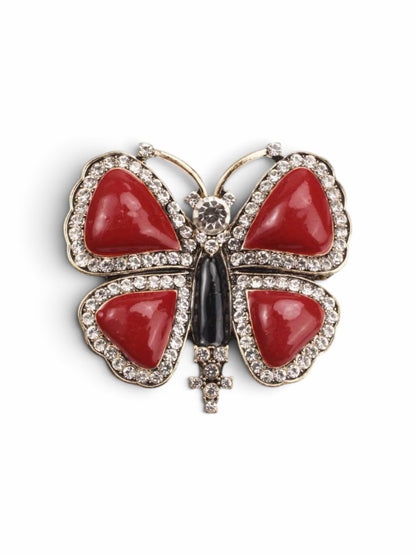 Luna Cotton butterfly lapel pin featuring vibrant red stone inlays, crystal accents, and a sleek black central body.