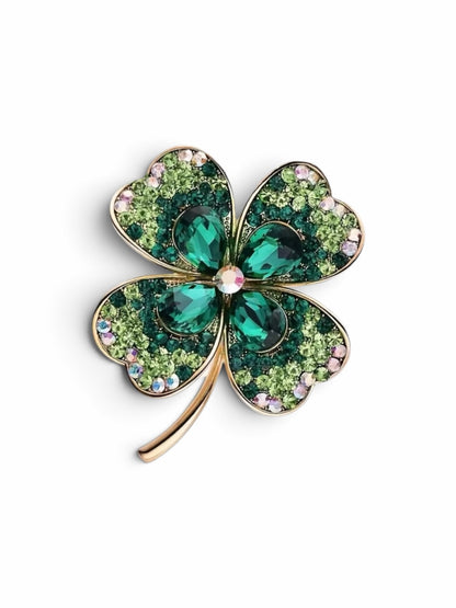 Luna Cotton four-leaf clover brooch in gold-tone metal with emerald marquise stones and light green pavé crystals.