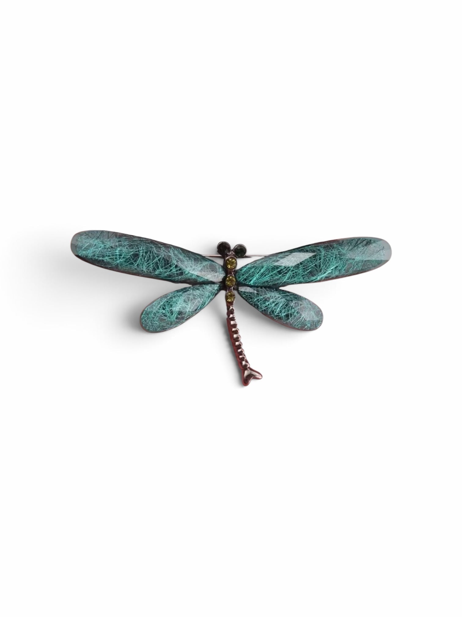 Luna Cotton dragonfly brooch with teal textured wings and a metallic body featuring small sparkling crystal accents.