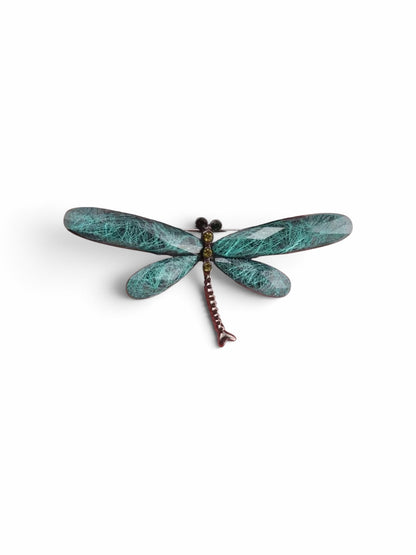 Luna Cotton dragonfly brooch with teal textured wings and a metallic body featuring small sparkling crystal accents.