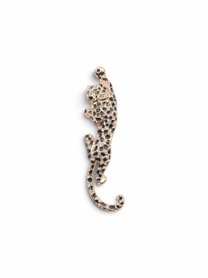 Luna Cotton leopard-shaped brooch in gold-tone metal with black enamel spots and sparkling crystal accents.