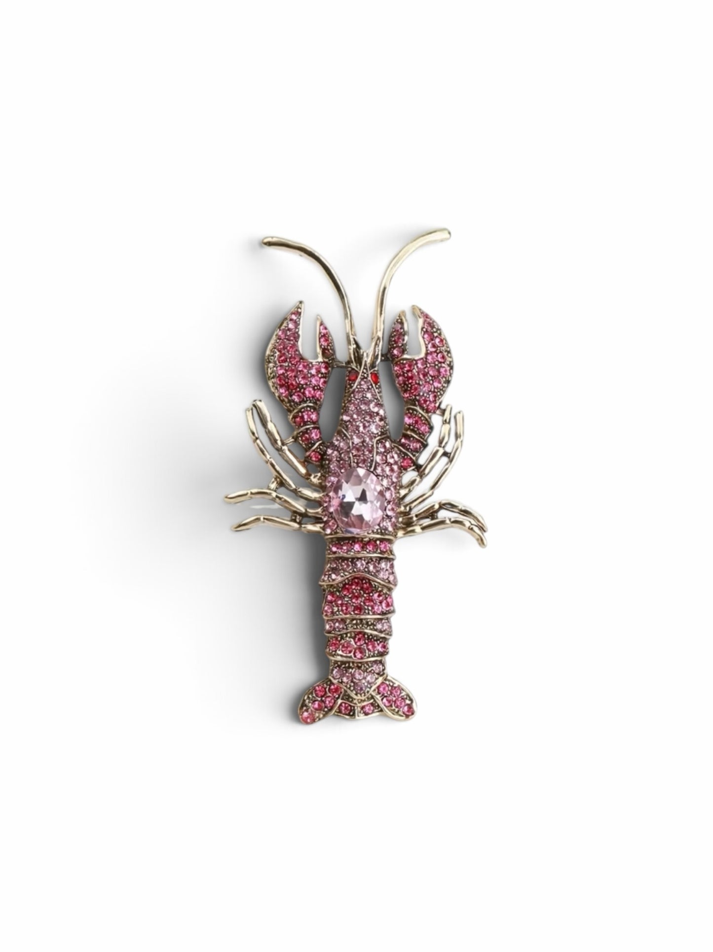 Luna Cotton lobster-shaped lapel pin brooch adorned with sparkling pink crystals and a central faceted stone.